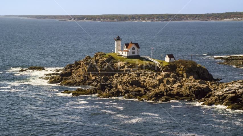 Cape Neddick Light, coastal town in background in autumn, York, Maine Aerial Stock Photo AX147_238.0000000 | Axiom Images