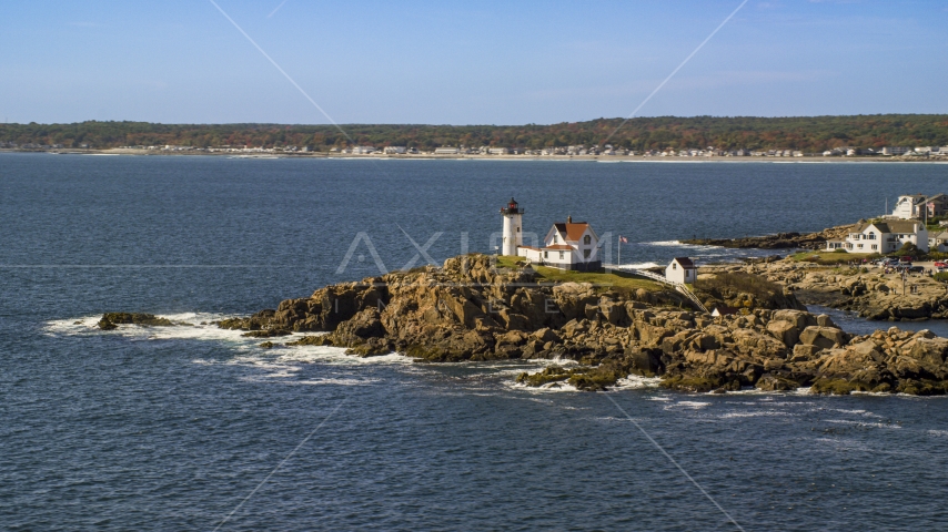 Cape Neddick Light, coastal town in background, autumn, York, Maine Aerial Stock Photo AX147_238.0000188 | Axiom Images