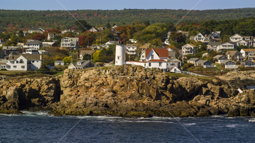 Cape Neddick Light, town behind it, autumn, York, Maine Aerial Stock Photo AX147_239.0000259 | Axiom Images