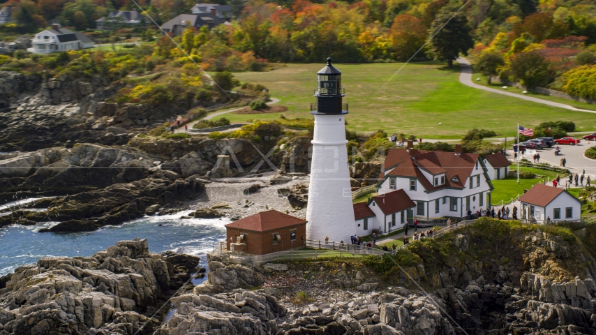 Portland Head Light on the rocky coast near colorful autumn trees, Cape Elizabeth, Maine Aerial Stock Photo AX147_313.0000047 | Axiom Images