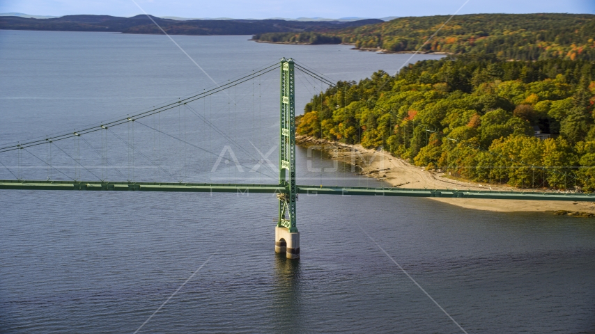 The Deer Isle Bridge near dense trees in autumn, Deer Isle Bridge, Maine Aerial Stock Photo AX148_141.0000000 | Axiom Images