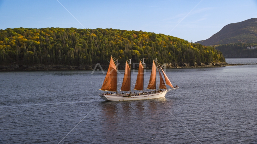 A sailing ship near an island with partial fall foliage, Bar Harbor, Maine Aerial Stock Photo AX148_198.0000184 | Axiom Images