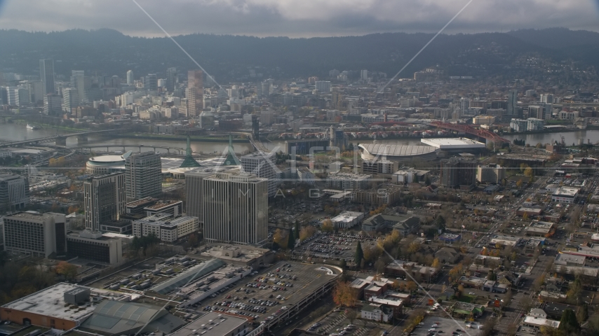 Downtown Portland behind office buildings and Moda Center, Oregon  Aerial Stock Photo AX153_111.0000319F | Axiom Images