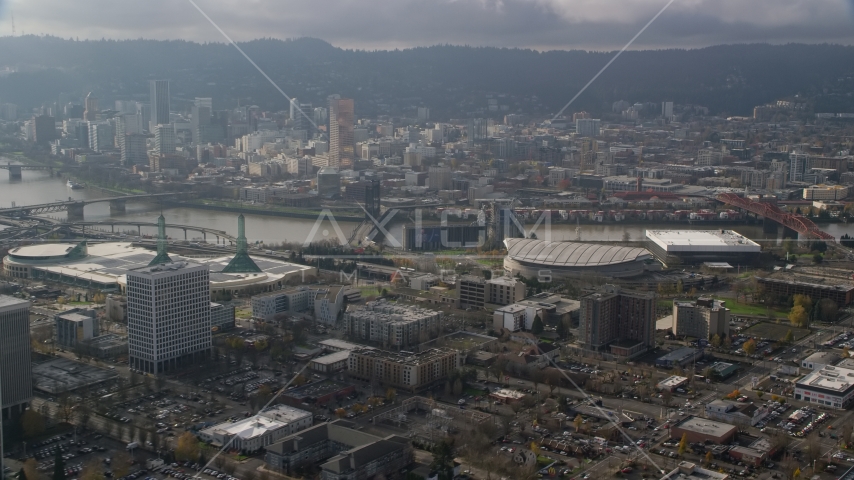 Downtown Portland skyscrapers across the Willamette River from Moda Center in Oregon Aerial Stock Photo AX153_112.0000199F | Axiom Images