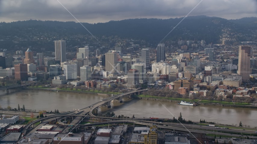 Downtown Portland skyscrapers across the Morrison Bridge and the Willamette River, Oregon Aerial Stock Photo AX153_121.0000355F | Axiom Images