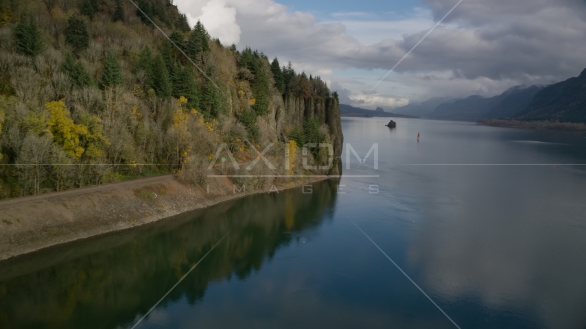 Railroad tracks below a cliff in the Columbia River Gorge, Oregon Aerial Stock Photo AX154_004.0000307F | Axiom Images