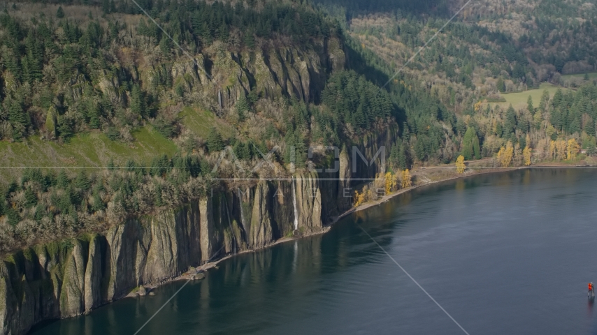 Four waterfalls on steep green cliffs beside the Columbia River on the Washington side of Columbia River Gorge Aerial Stock Photo AX154_195.0000171F | Axiom Images