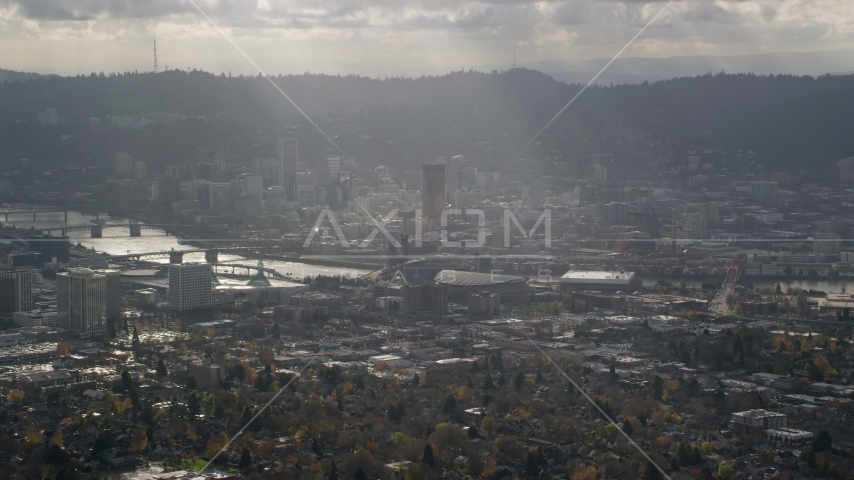 Godrays shining down on Moda Center, the Willamette River and Downtown Portland, Oregon Aerial Stock Photo AX154_224.0000000F | Axiom Images