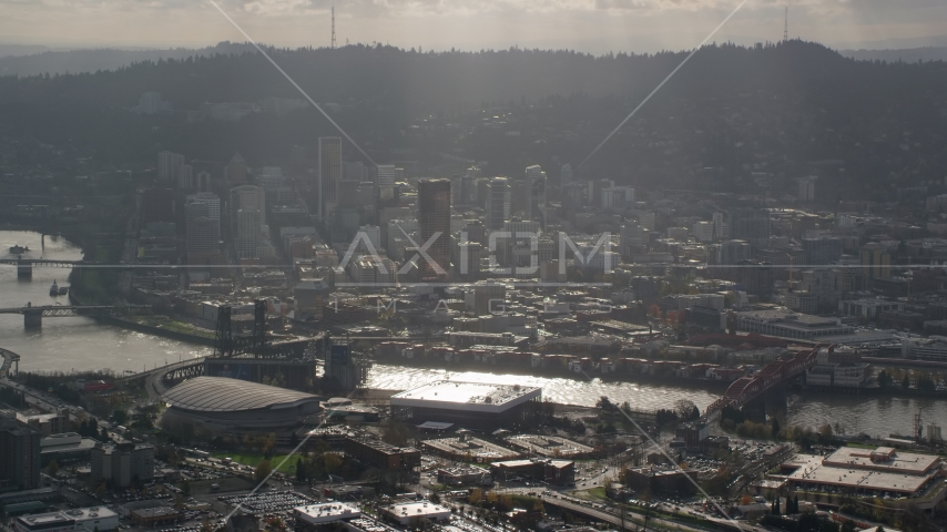 Godrays coming down on Moda Center, the Willamette River and Downtown Portland, Oregon Aerial Stock Photo AX154_225.0000228F | Axiom Images