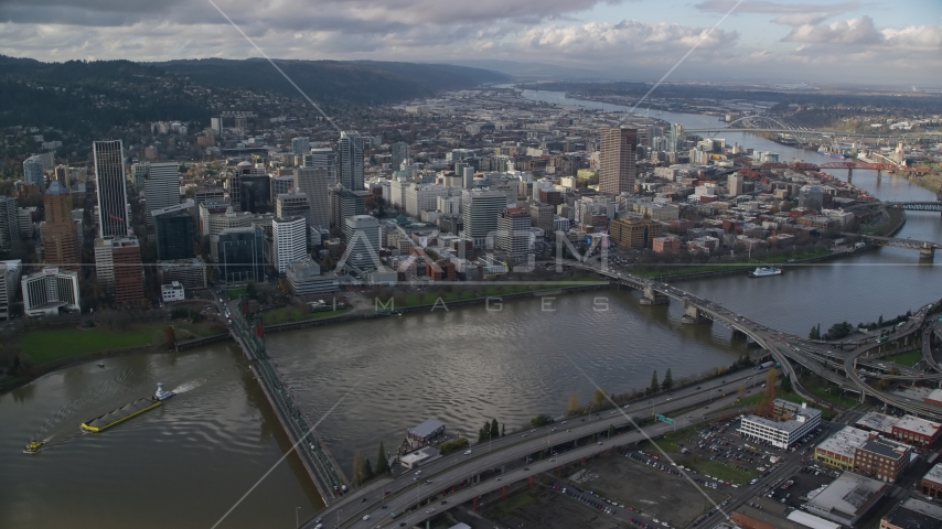 Skyscrapers in Downtown Portland, Oregon, across the Willamette River bridges Aerial Stock Photo AX154_235.0000247F | Axiom Images