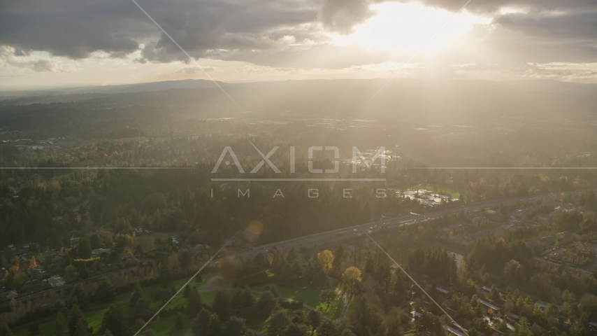 Godrays shining down on suburban neighborhoods and Highway 26, Southwest Portland, Oregon Aerial Stock Photo AX155_119.0000265F | Axiom Images