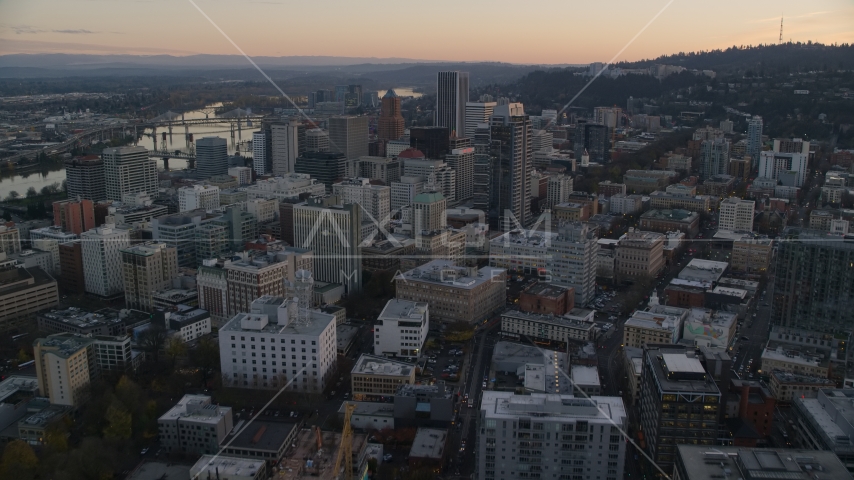 NW 10th Avenue through Downtown Portland, Oregon, at sunset to Park Avenue West Tower Aerial Stock Photo AX155_164.0000248F | Axiom Images