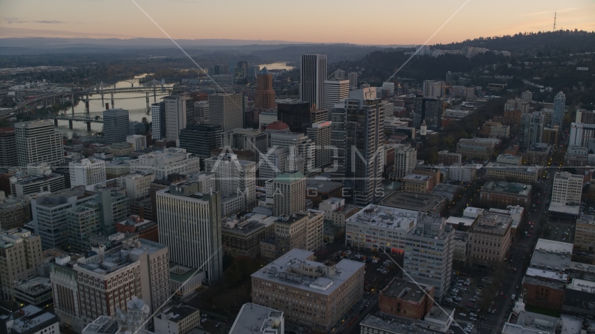 NW 10th Avenue through Downtown Portland, Oregon, at sunset to Park Avenue West Tower Aerial Stock Photo AX155_164.0000342F | Axiom Images