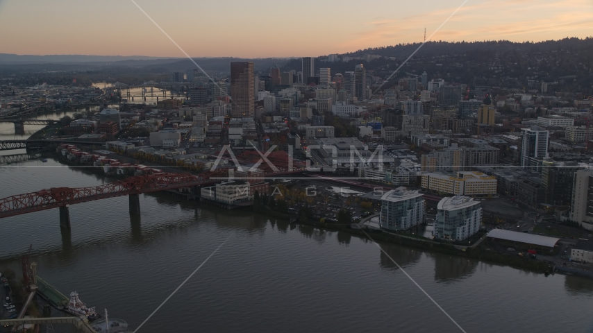 Downtown Portland skyscrapers and Union Station seen from near the Broadway Bridge at sunset in Oregon Aerial Stock Photo AX155_184.0000216F | Axiom Images