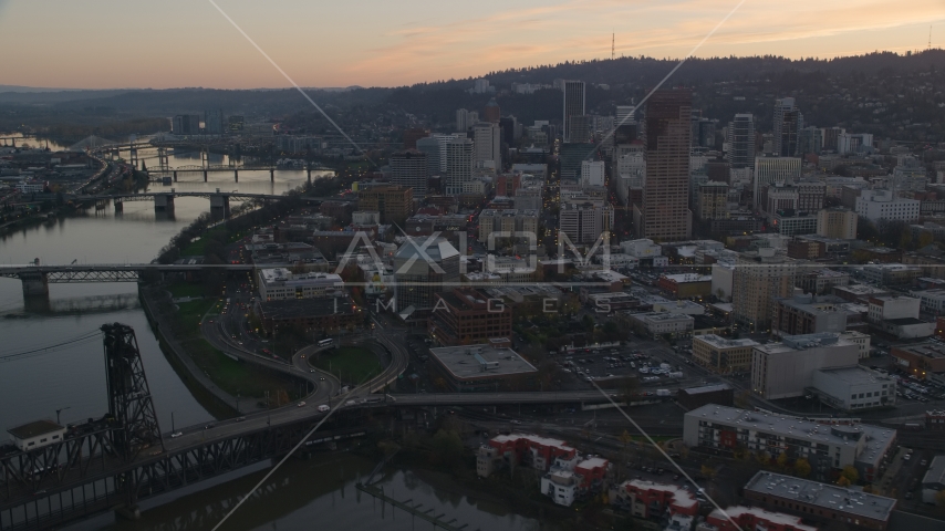 Downtown Portland skyscrapers and Union Station seen from over the Broadway Bridge at sunset in Oregon Aerial Stock Photo AX155_185.0000359F | Axiom Images