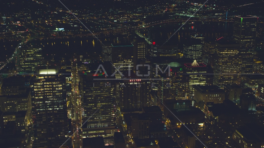 High-rises and skyscrapers by the Willamette River at night in Downtown Portland, Oregon Aerial Stock Photo AX155_392.0000237F | Axiom Images