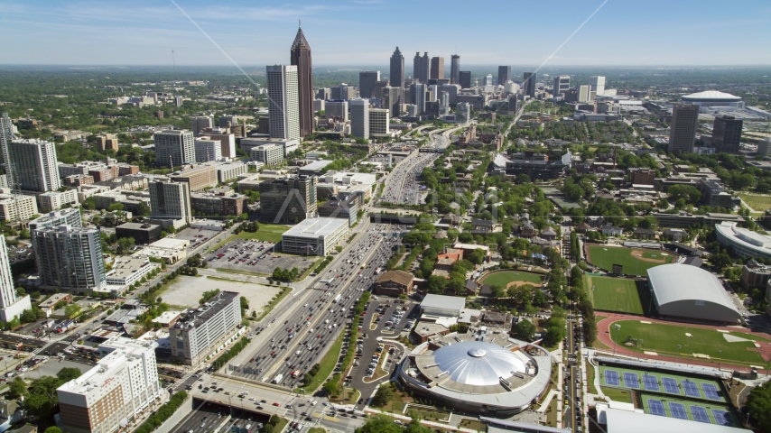 Alexander Memorial Coliseum along Downtown Connector toward Midtown Atlanta skyscrapers, Georgia Aerial Stock Photo AX37_035.0000150F | Axiom Images