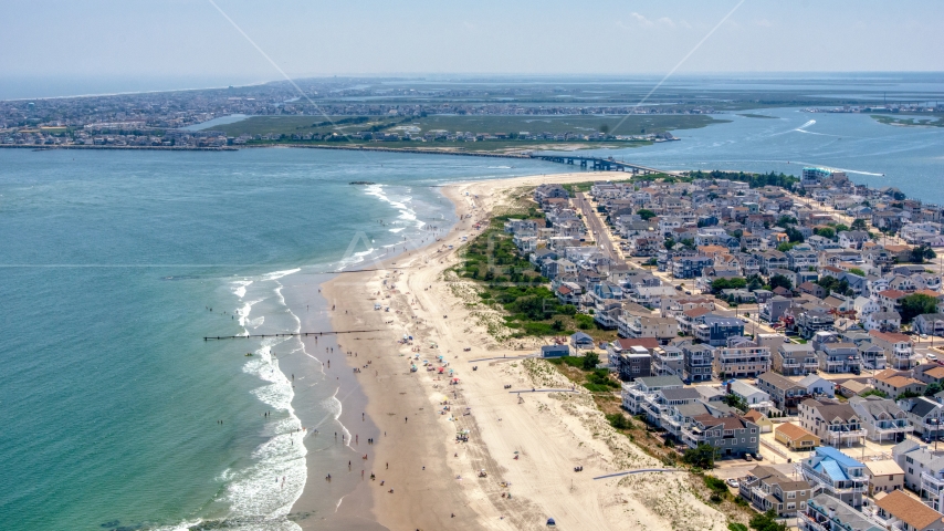 Beach goers by beachfront homes near Townsends Inlet Bridge in Sea Isle City, New Jersey Aerial Stock Photo AXP071_000_0027F | Axiom Images