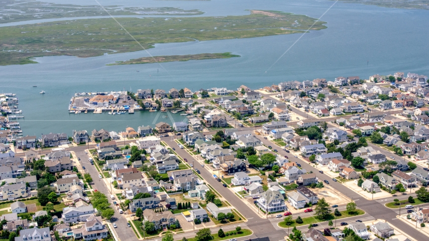 Waterfront homes by Snug Harbor in Stone Harbor, New Jersey Aerial Stock Photo AXP071_000_0029F | Axiom Images