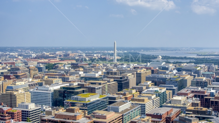 The Washington Monument seen from office building rooftops in Washington DC Aerial Stock Photo AXP075_000_0012F | Axiom Images