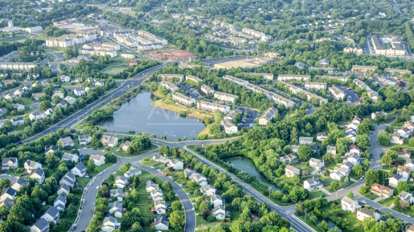 Waterfront row houses and homes by a small pond in Manassas, Virginia Aerial Stock Photo AXP075_000_0027F | Axiom Images