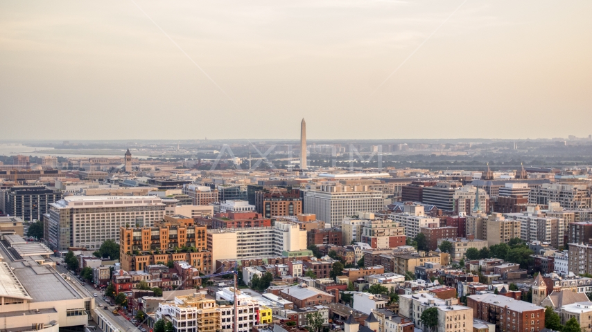 A wide view of the Jefferson Memorial, Washington Monument and city buildings in Washington D.C., sunset Aerial Stock Photo AXP076_000_0017F | Axiom Images