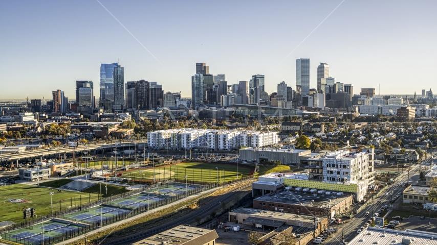 City skyline behind apartment buildings and sports fields, Downtown Denver, Colorado Aerial Stock Photo DXP001_000119 | Axiom Images