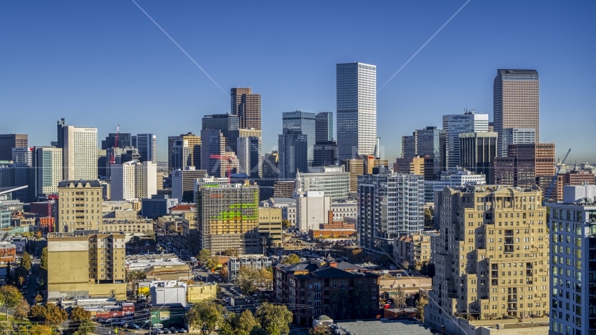 Giant skyscrapers in the city's skyline behind office buildings, Downtown Denver, Colorado Aerial Stock Photo DXP001_000131 | Axiom Images