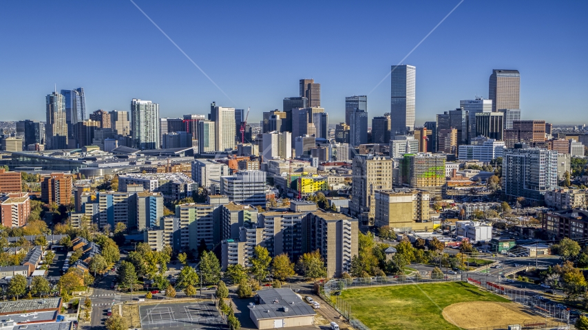 City skyline's tall skyscrapers behind apartment and office buildings, Downtown Denver, Colorado Aerial Stock Photo DXP001_000134 | Axiom Images