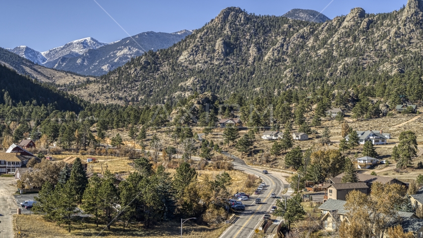 Rural homes beside a road near rugged mountains, Estes Park, Colorado Aerial Stock Photo DXP001_000228 | Axiom Images