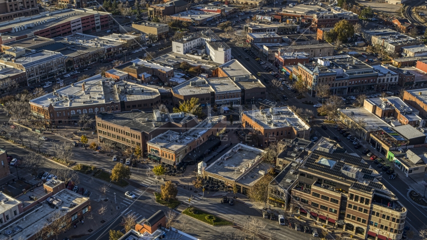 Shops and brick office buildings lining a quiet street in Fort Collins, Colorado Aerial Stock Photo DXP001_000242 | Axiom Images