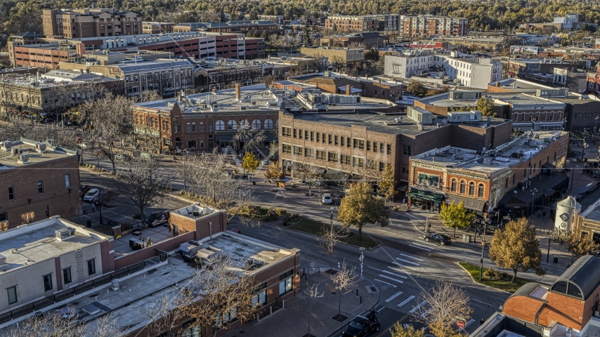 Shops and brick office buildings beside a quiet street in Fort Collins, Colorado Aerial Stock Photo DXP001_000243 | Axiom Images