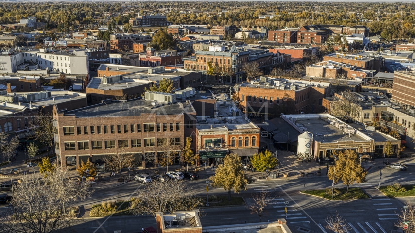 A brick office building beside a shop with a green awning in Fort Collins, Colorado Aerial Stock Photo DXP001_000245 | Axiom Images