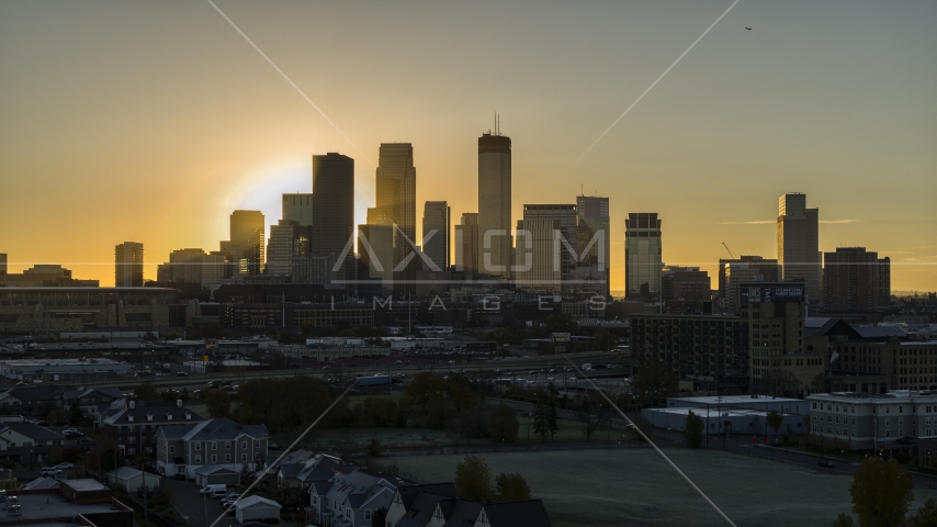 The rising sun behind towering skyscrapers in the city's skyline in Downtown Minneapolis, Minnesota Aerial Stock Photo DXP001_000261 | Axiom Images