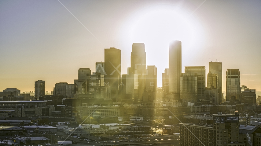 Rays of sunlight from behind giant skyscrapers in the city's skyline at sunrise in Downtown Minneapolis, Minnesota Aerial Stock Photo DXP001_000270 | Axiom Images