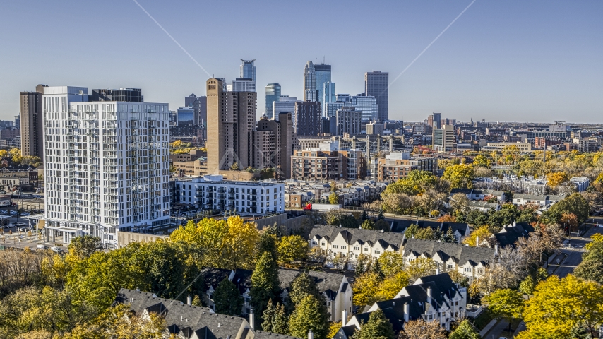 Apartment and condo complexes in the foreground, city skyline's skyscrapers in the background, Downtown Minneapolis, Minnesota Aerial Stock Photo DXP001_000286 | Axiom Images