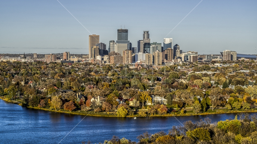 Lakefront homes and city skyline seen from Lake of the Isles, Downtown Minneapolis, Minnesota Aerial Stock Photo DXP001_000321 | Axiom Images