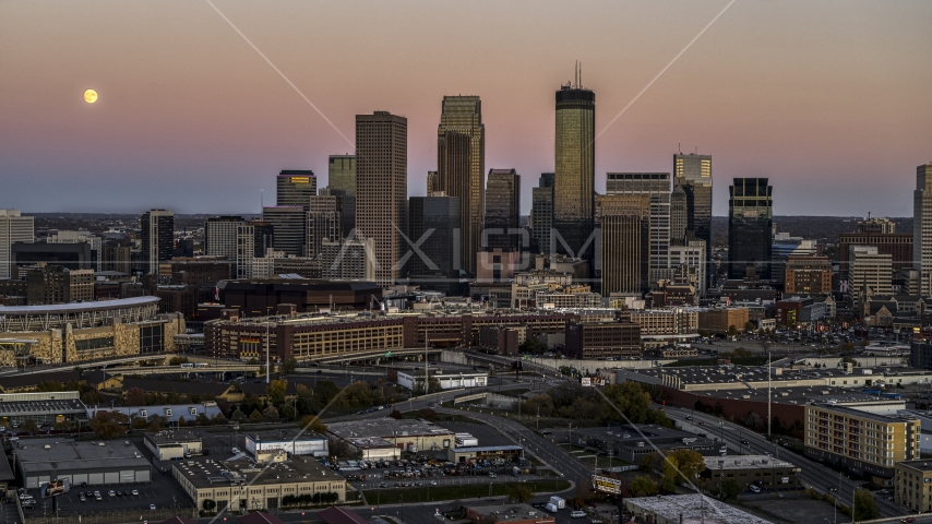 The moon in the sky near the city's skyline at twilight in Downtown Minneapolis, Minnesota Aerial Stock Photo DXP001_000329 | Axiom Images