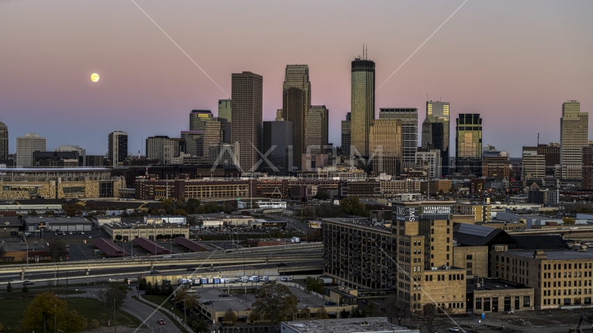 The moon in the sky near the skyscrapers of the city's skyline at twilight, Downtown Minneapolis, Minnesota Aerial Stock Photo DXP001_000331 | Axiom Images