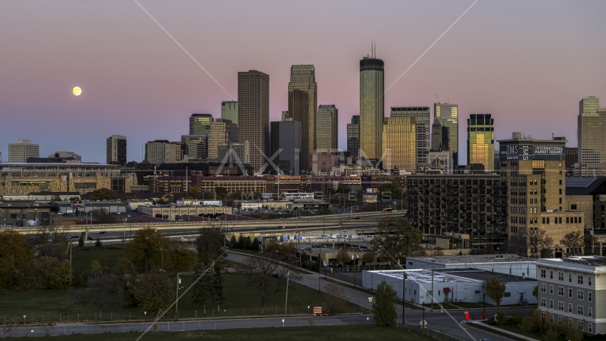 The moon in the sky near the giant skyscrapers of the city's skyline at twilight, Downtown Minneapolis, Minnesota Aerial Stock Photo DXP001_000333 | Axiom Images