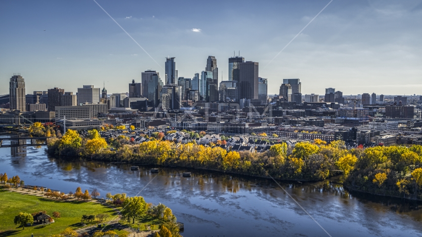 City skyline's skyscrapers seen from the Mississippi River with fall trees, Downtown Minneapolis, Minnesota Aerial Stock Photo DXP001_000397 | Axiom Images