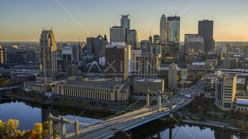 Skyline seen from the Hennepin Avenue Bridge spanning the river at sunset, Downtown Minneapolis, Minnesota Aerial Stock Photo DXP001_000414 | Axiom Images