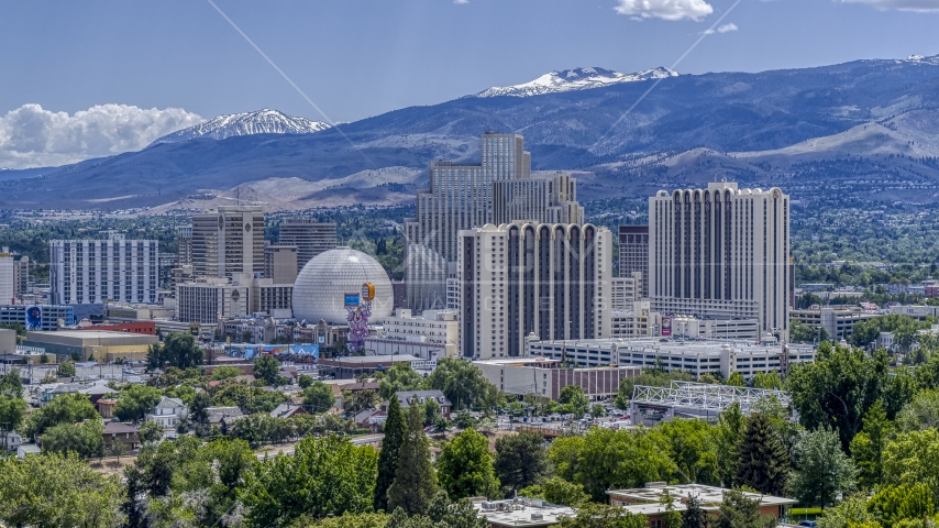 Hotels and casinos with mountains in the background in Reno, Nevada Aerial Stock Photo DXP001_004_0004 | Axiom Images