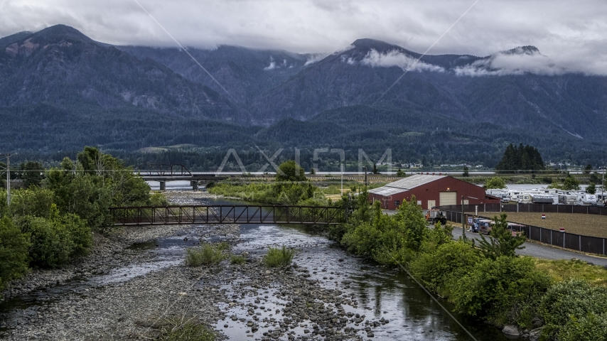 Bridges spanning creek, and mountains across the Columbia River at sunrise, Stevenson, Washington Aerial Stock Photo DXP001_008_0003 | Axiom Images