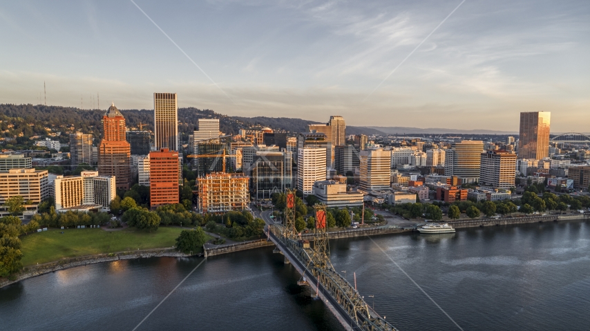 Tall skyscrapers across the Hawthorne Bridge spanning the Willamette River, Downtown Portland, Oregon Aerial Stock Photo DXP001_010_0008 | Axiom Images