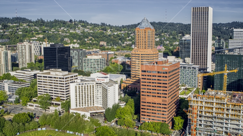 Hotel by office buildings and tall skyscrapers in Downtown Portland, Oregon Aerial Stock Photo DXP001_011_0006 | Axiom Images