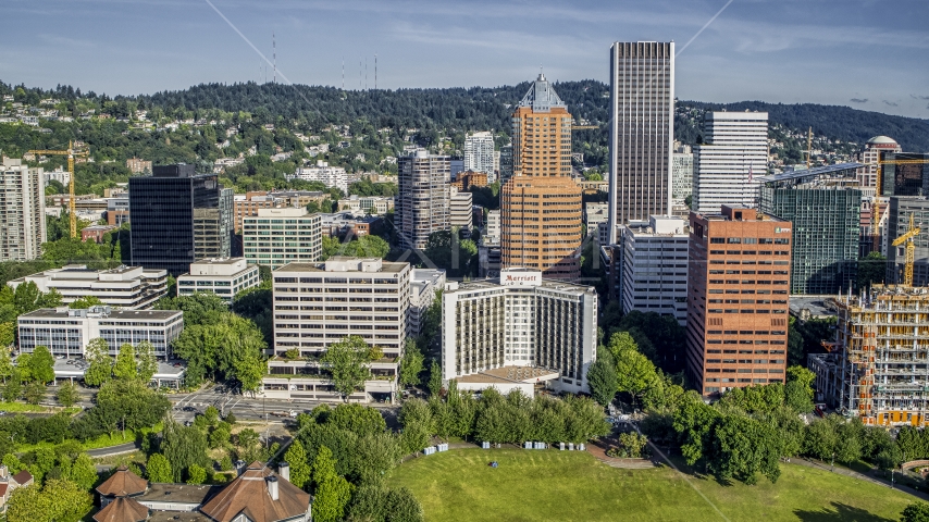 Hotel surrounded by office buildings and tall skyscrapers in Downtown Portland, Oregon Aerial Stock Photo DXP001_011_0007 | Axiom Images