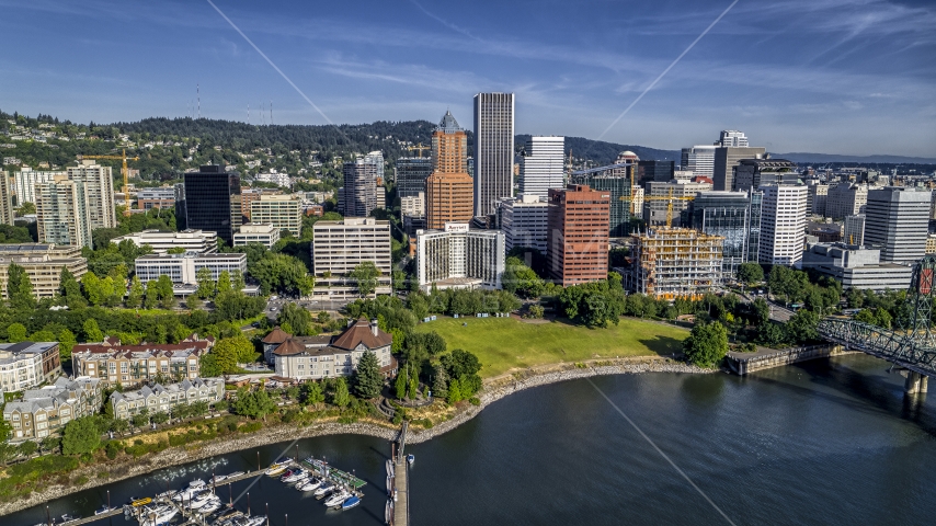 Office buildings and towering skyscrapers by the river in Downtown Portland, Oregon Aerial Stock Photo DXP001_011_0015 | Axiom Images