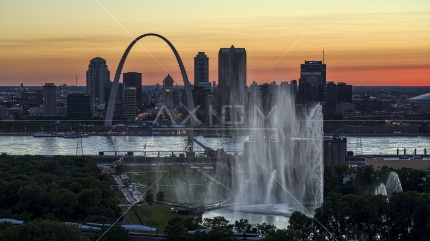 The Gateway Geyser with the Arch in the background, Downtown St. Louis, Missouri, twilight Aerial Stock Photo DXP001_030_0002 | Axiom Images