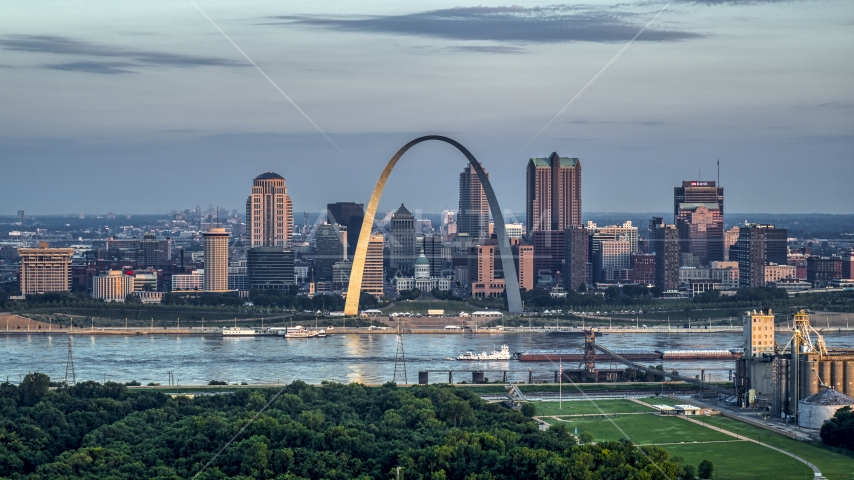 A view of the Gateway Arch by the Mississippi River at sunrise in Downtown St. Louis, Missouri Aerial Stock Photo DXP001_038_0004 | Axiom Images